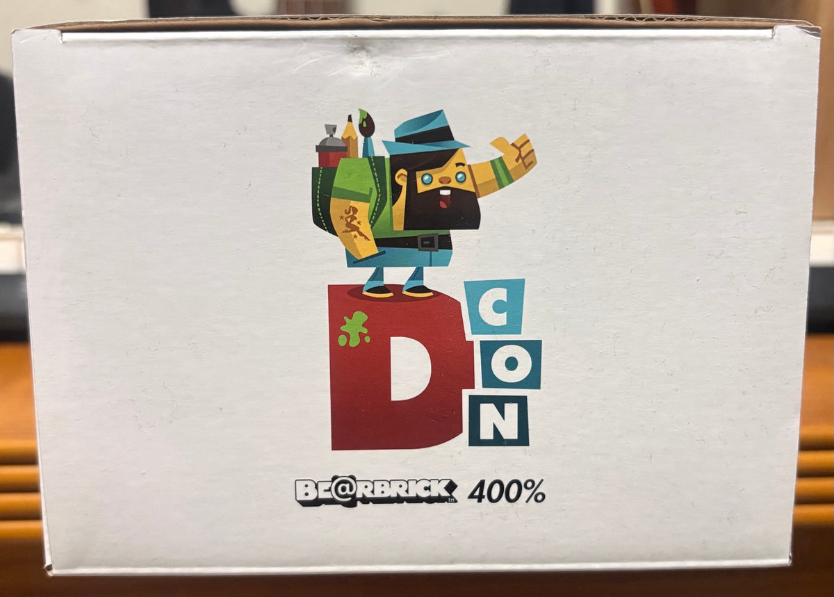 Actual item box side: DesignerCon artwork, BE@RBRICK 400% mark and visible box handling wear